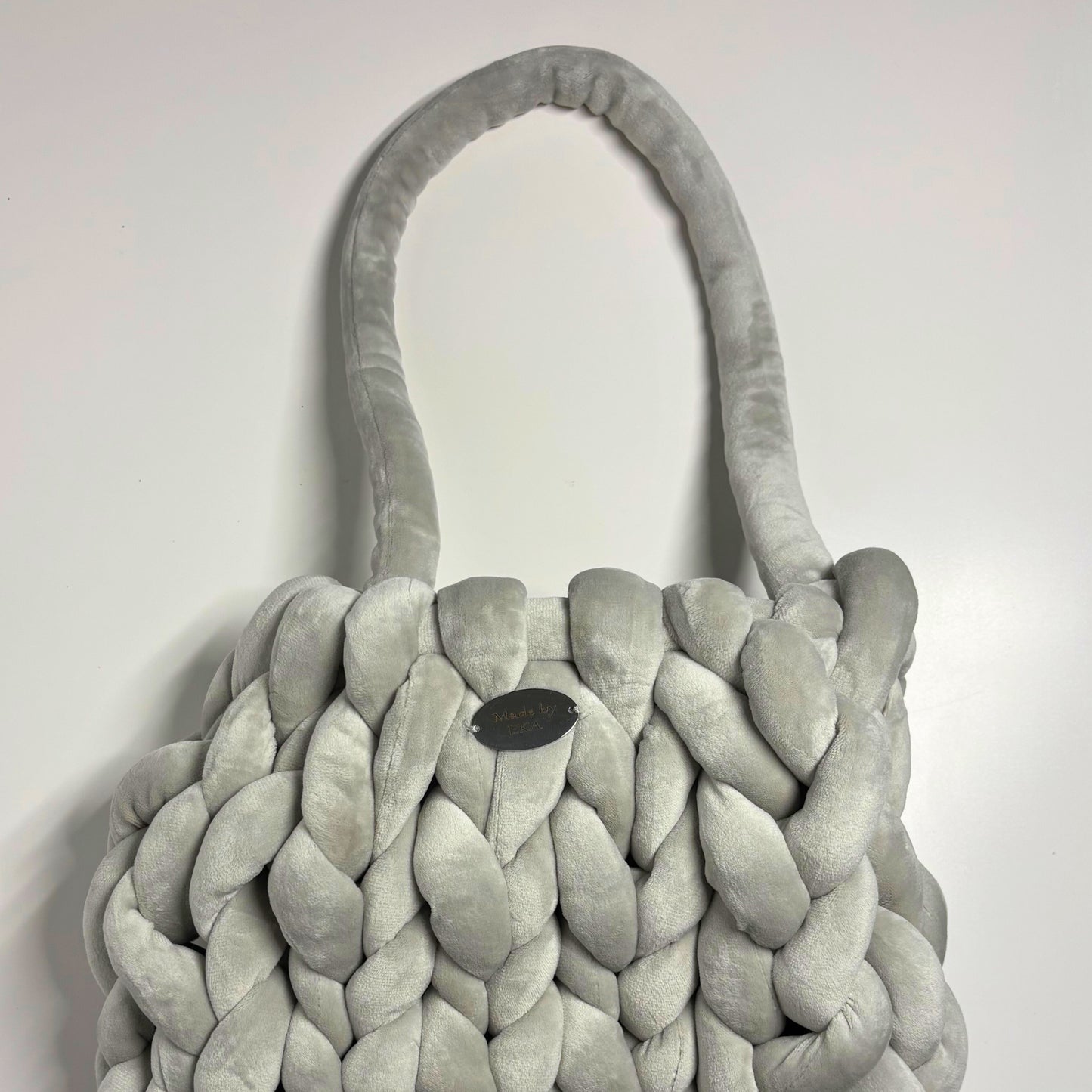 Gray braided bag on a light gray background