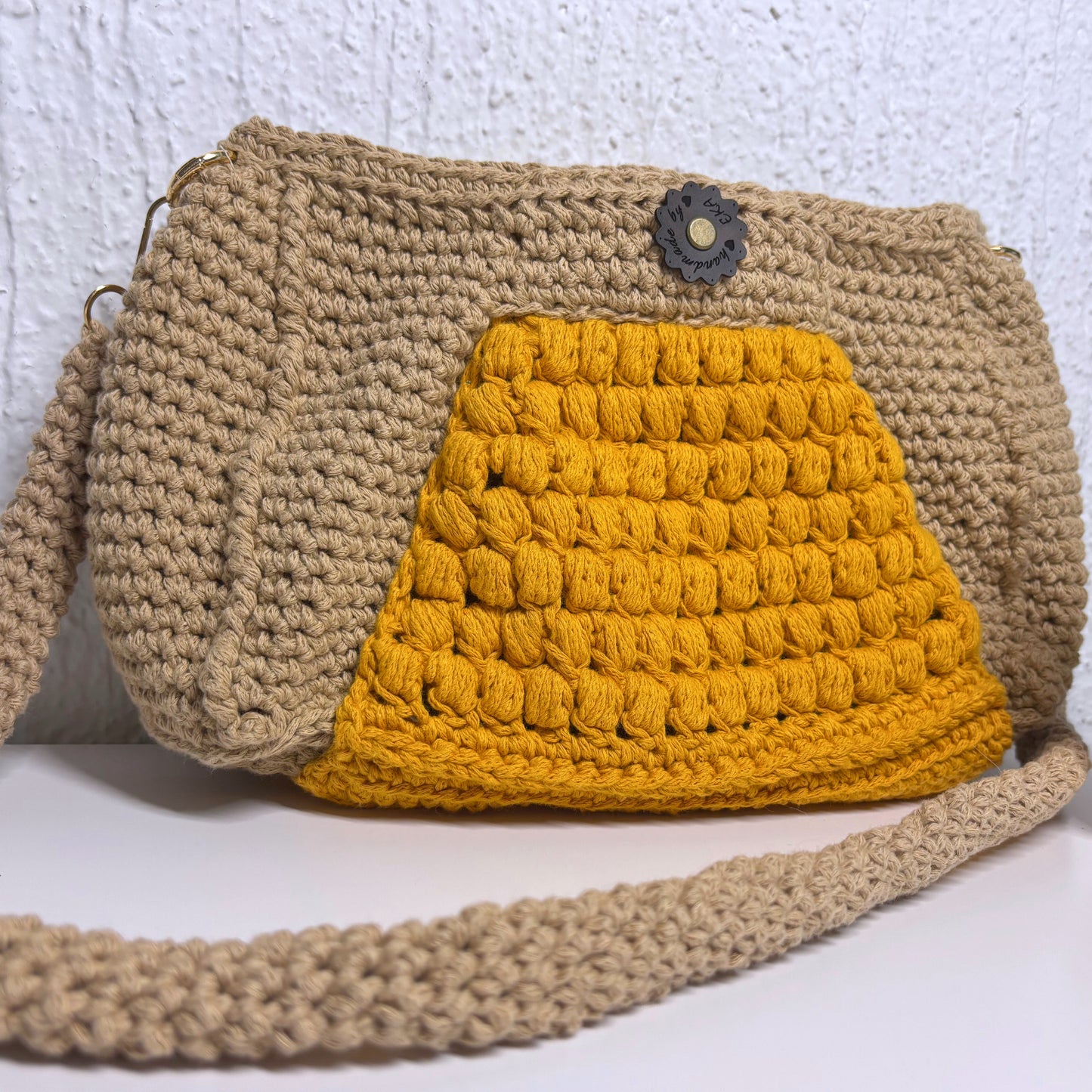 Crocheted beige and yellow bag on a white background