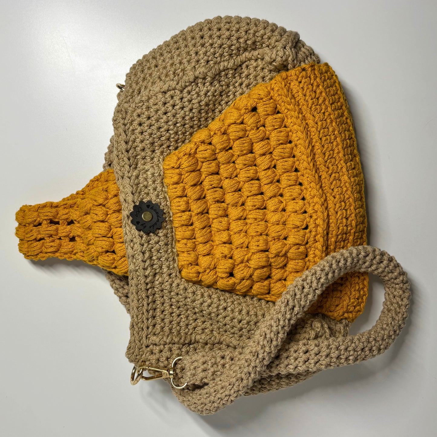 Crocheted bag with brown and orange colors on a white background