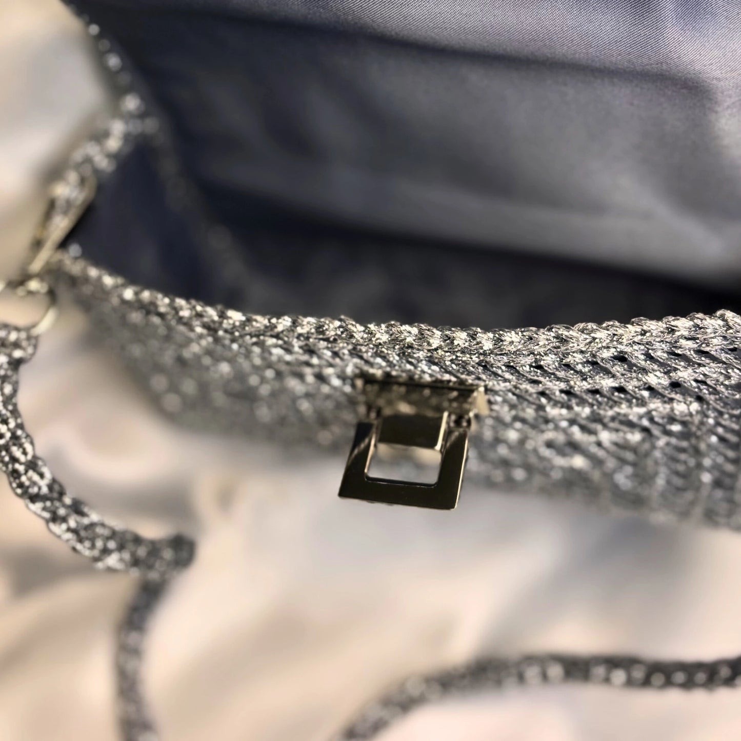 Close-up of a textured silver handbag with a blurred background