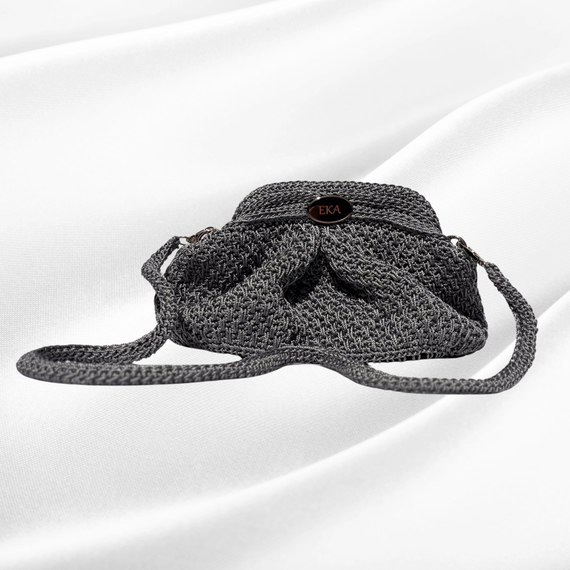 Silver crochet purse on a white background.