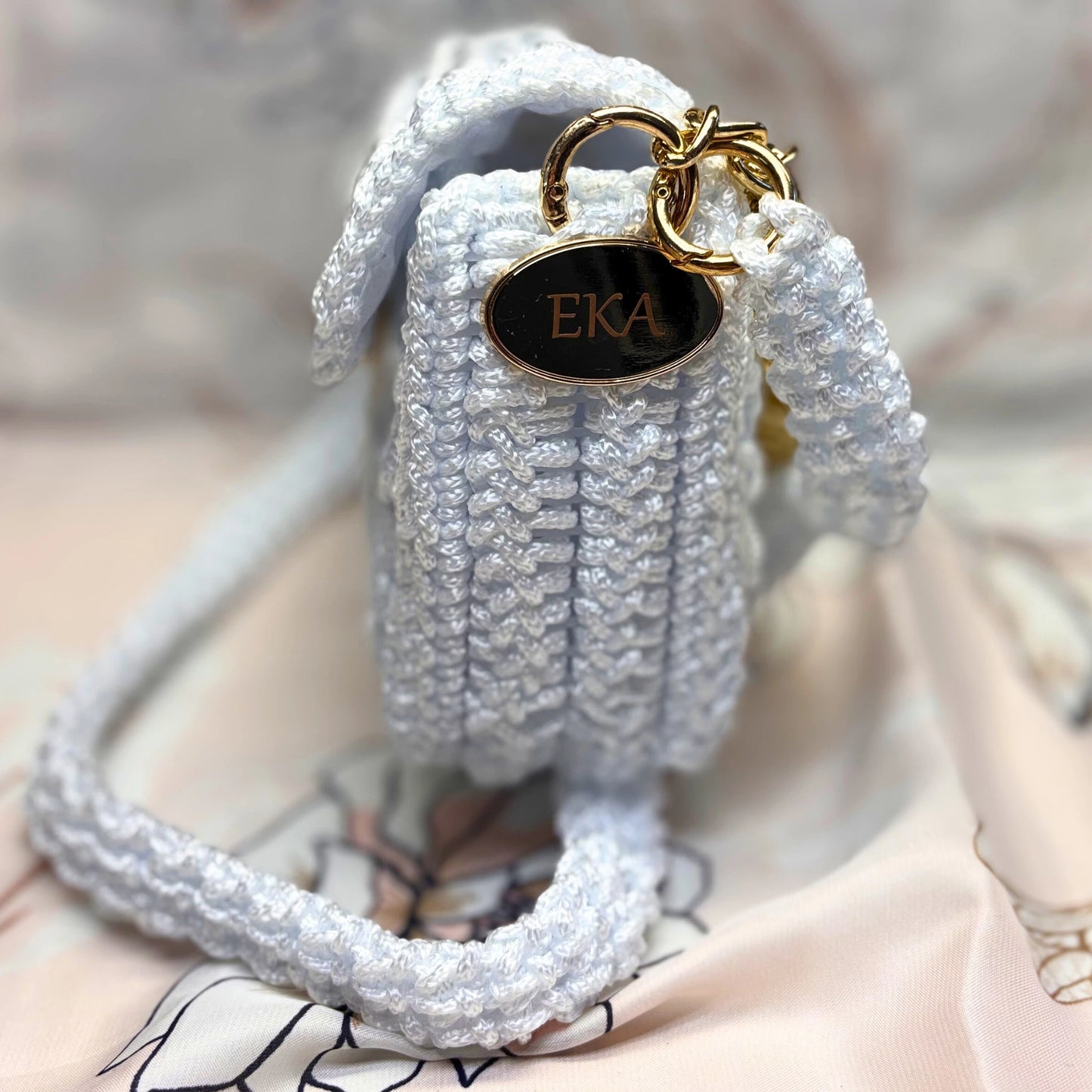 White bridal purse with gold chain from the side on a light background